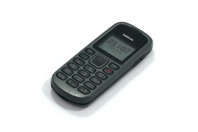 Nokia mobile phone with a numeric keypad and a digital display showing the time. The device has a simple design and a dark color scheme.